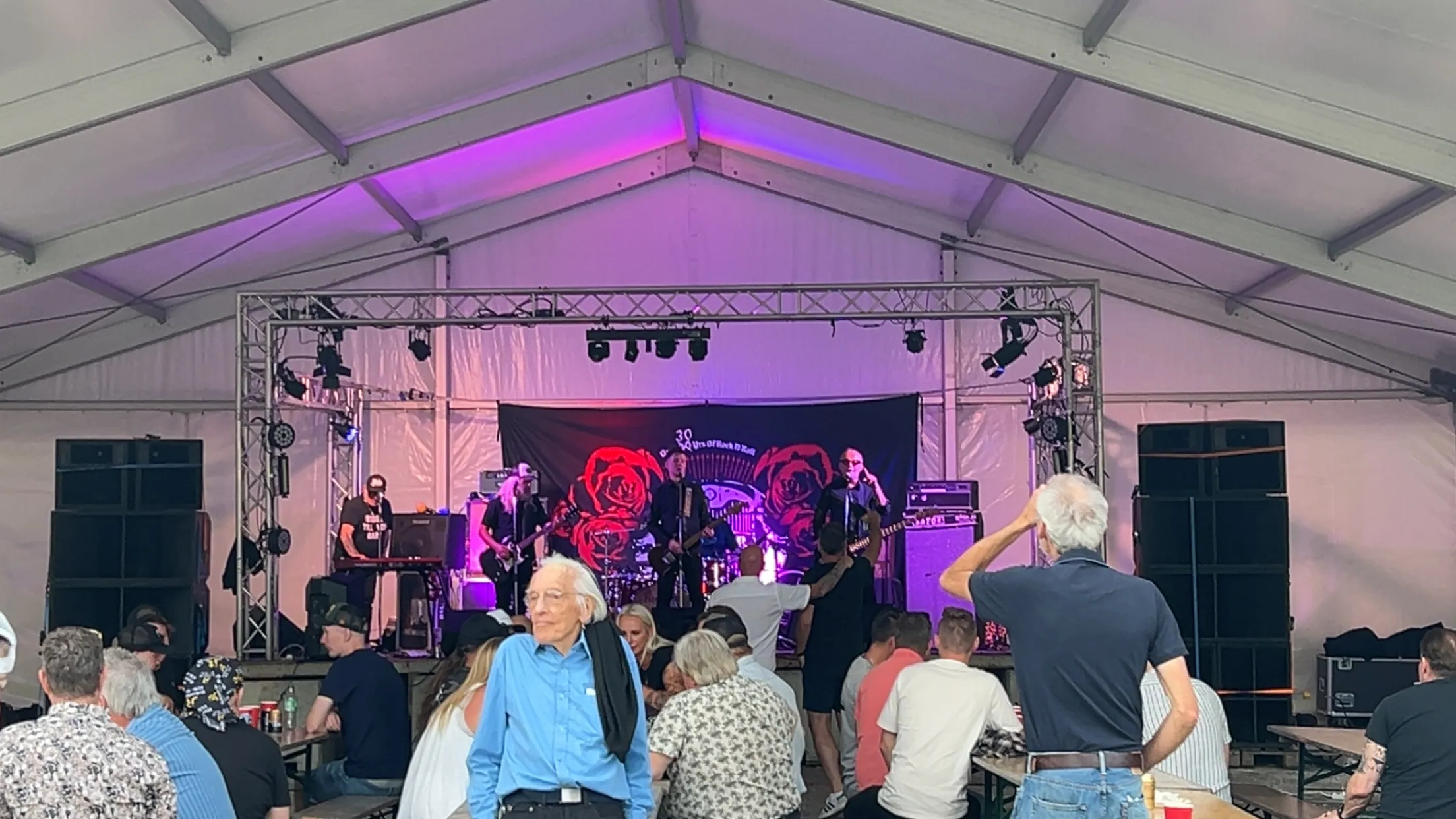 people standing on stage with lights